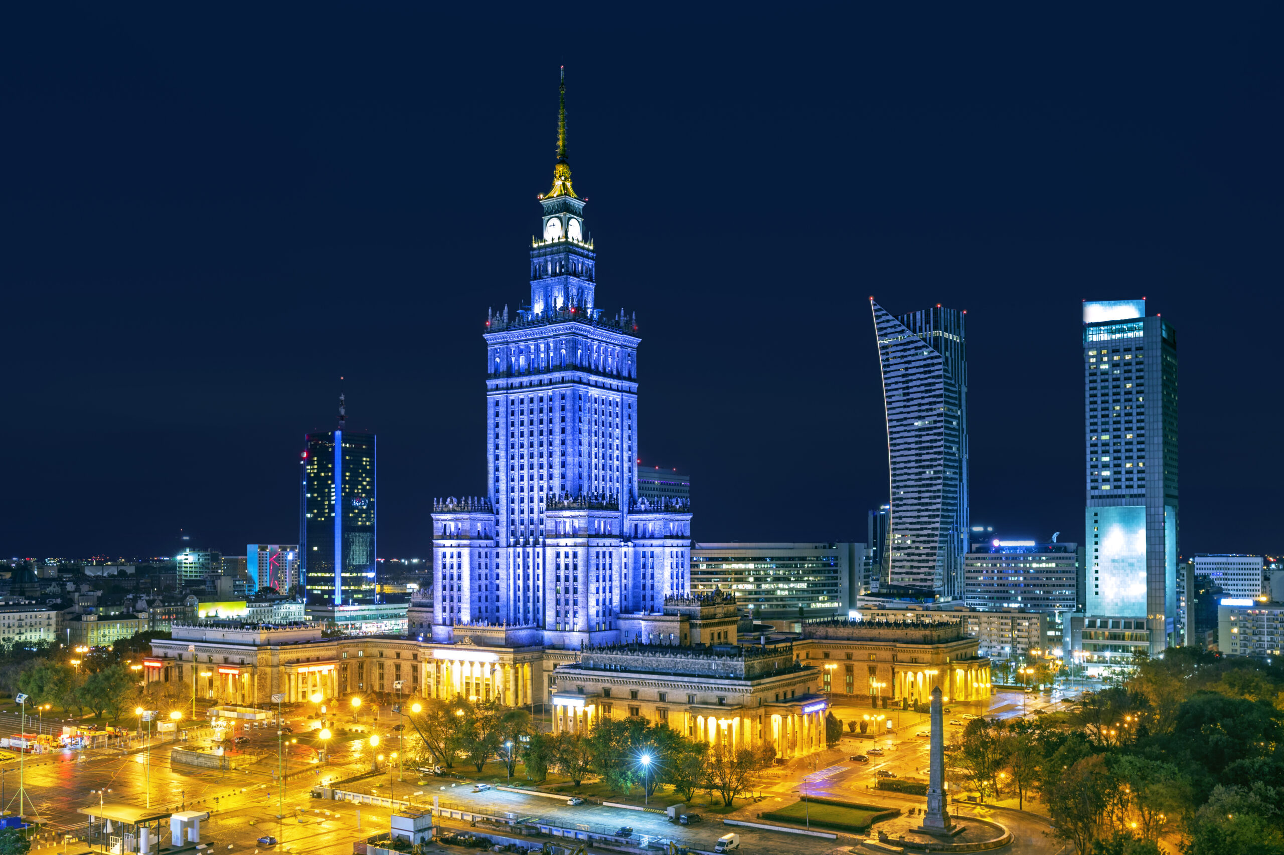 Palace of Culture and Science illuminated at night, showcasing Warsaw's iconic skyline and vibrant nightlife.