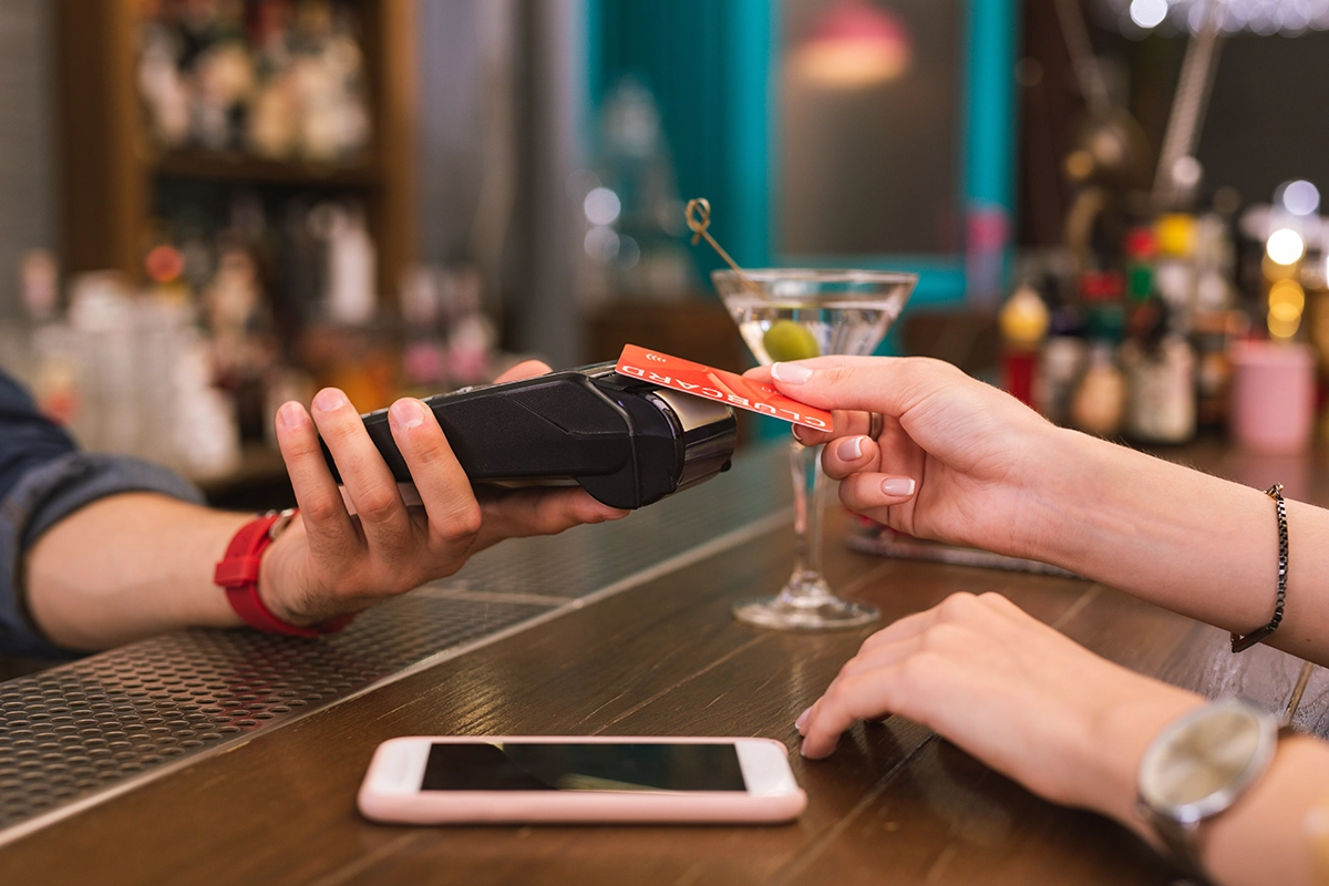 Contactless card payment for a cocktail at a bar - Warsaw nightlife budget